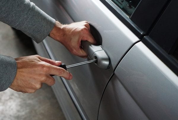 Thief breaking into car