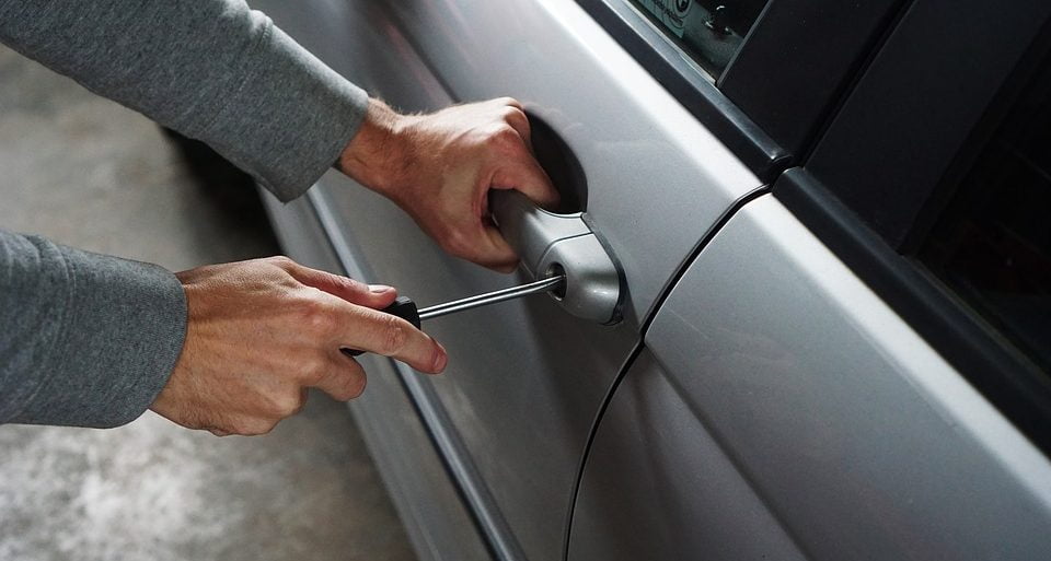 Thief breaking into car